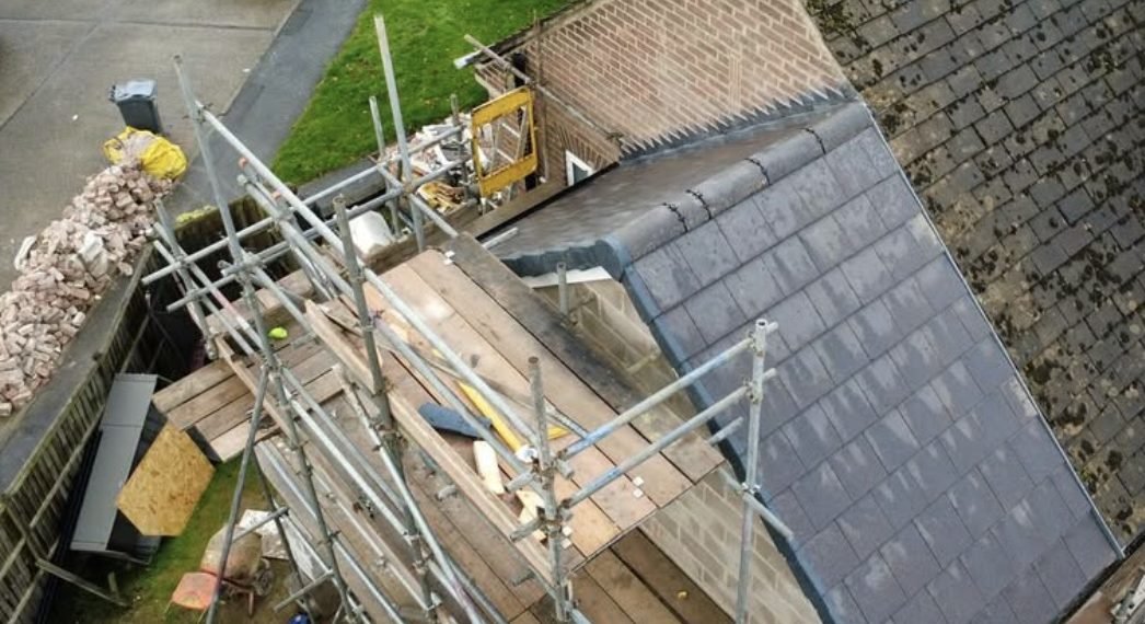 Extension roof seen from above with scaffold boards alongside