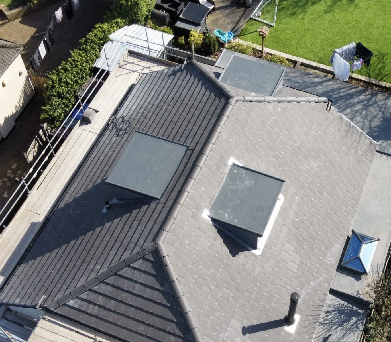 Overhead view of a tiled roof with dormers and rooflights